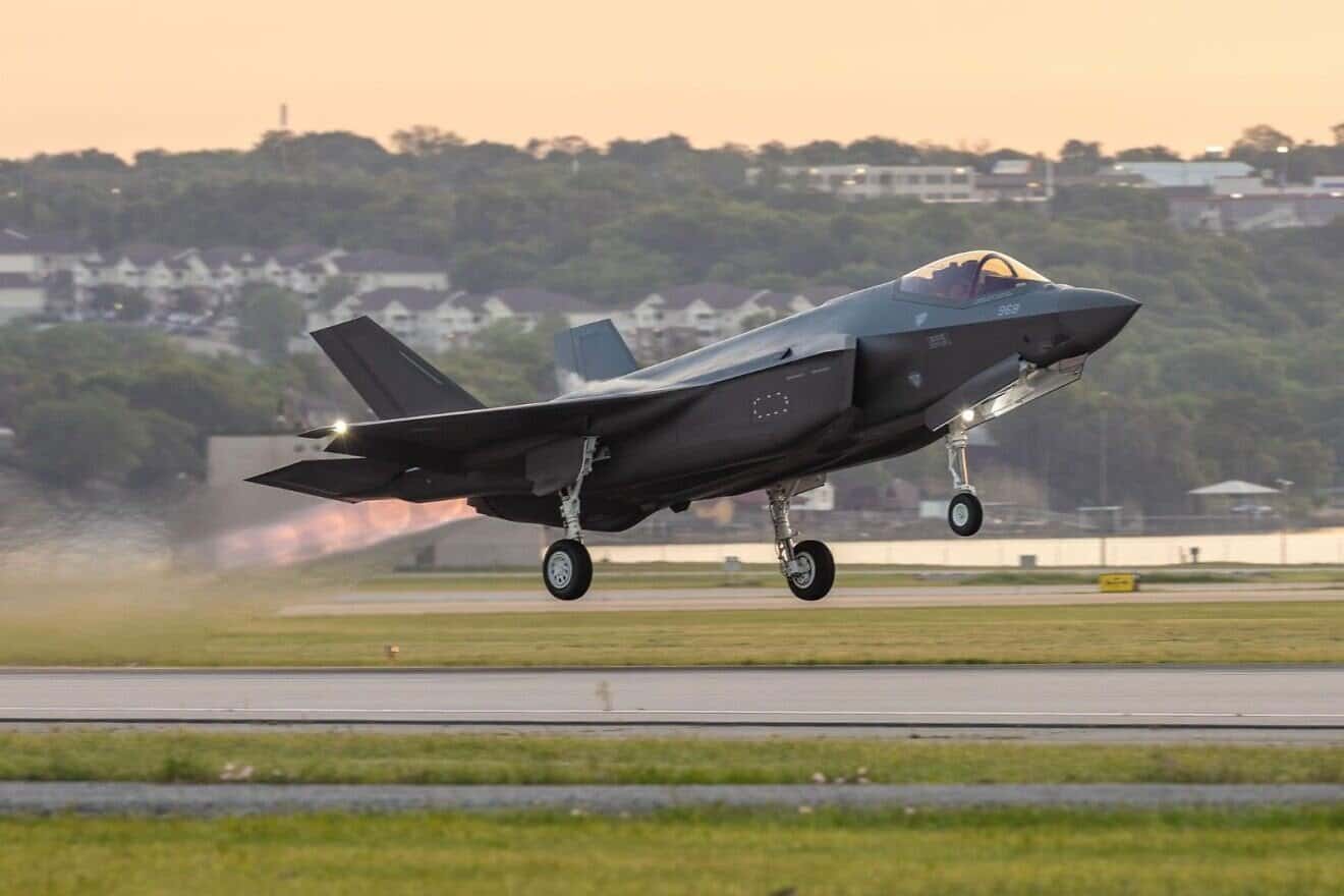 An F-35 fighter jet lifts off a runway, representing the advanced aerial assets potentially involved in military operations.