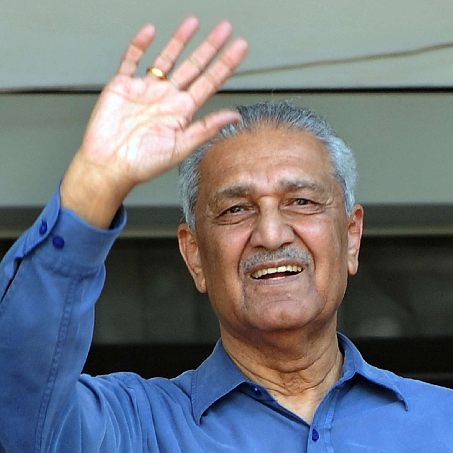 Abdul Qadeer Khan, the Pakistani nuclear scientist, waving to the camera.