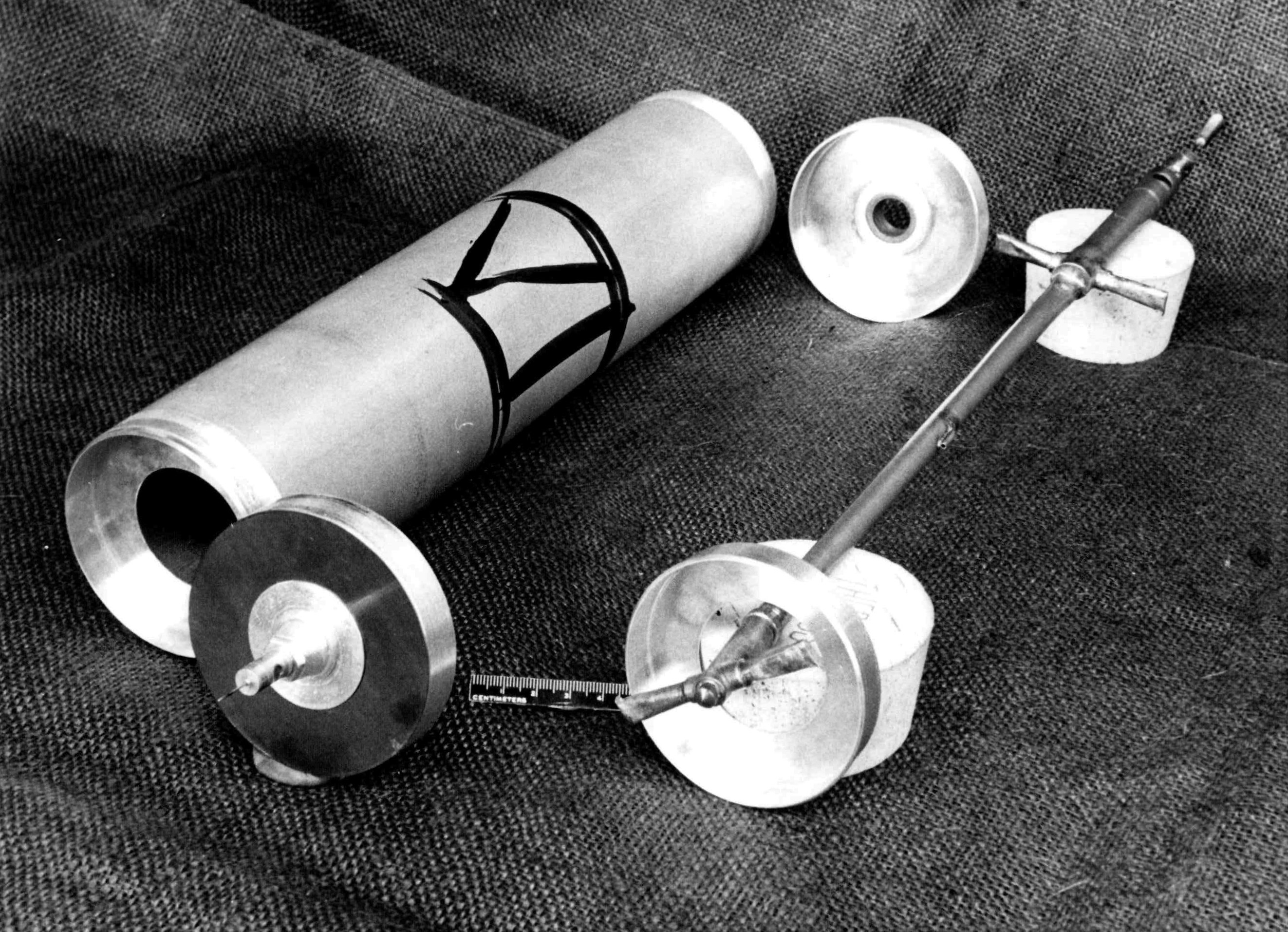 Components of a Zippe-type gas centrifuge, showing the rotor casing and internal shaft assembly.