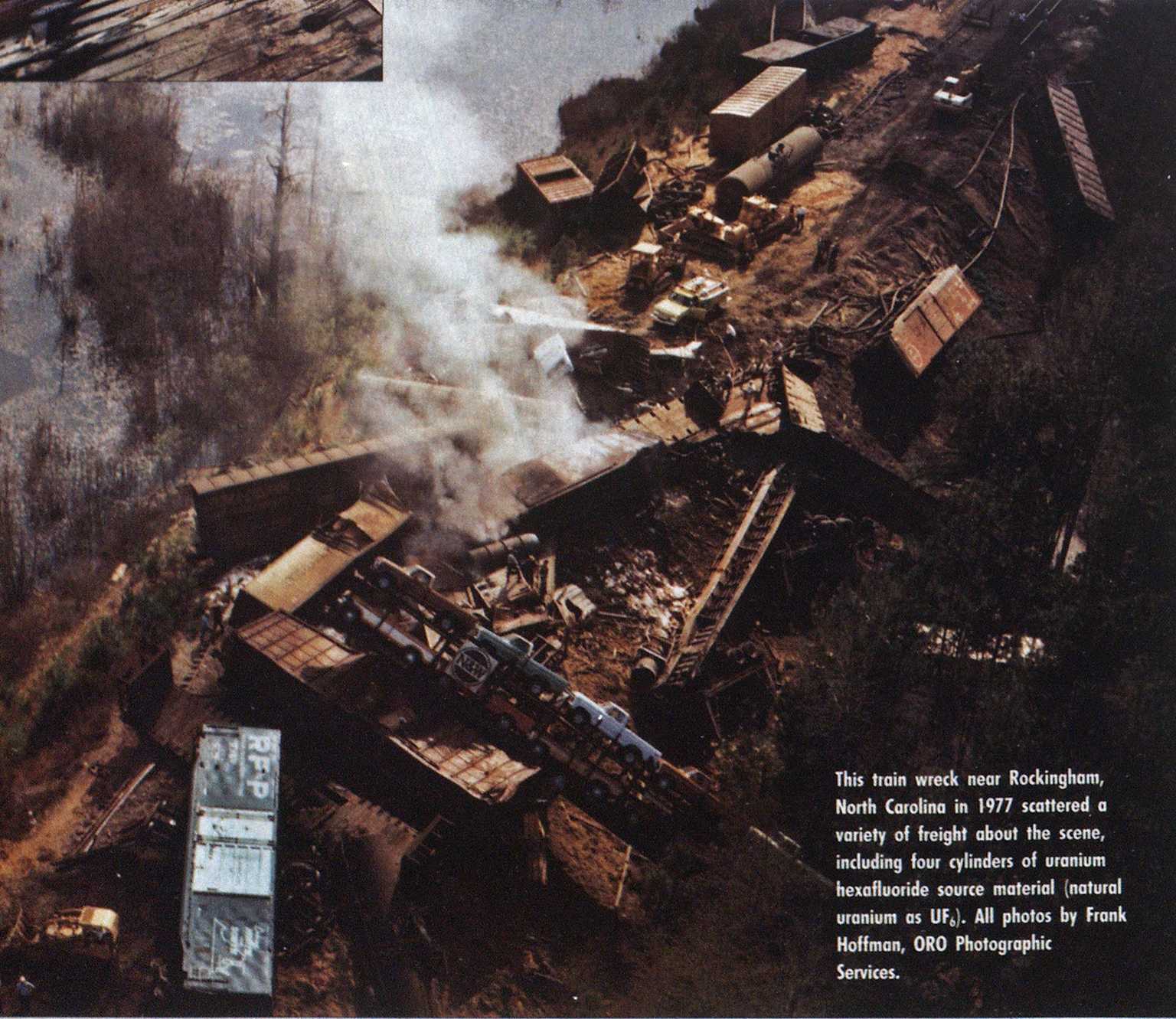 Aerial view of a train derailment in Rockingham, North Carolina, in 1977, involving scattered freight and four uranium hexafluoride (UF6) cylinders.