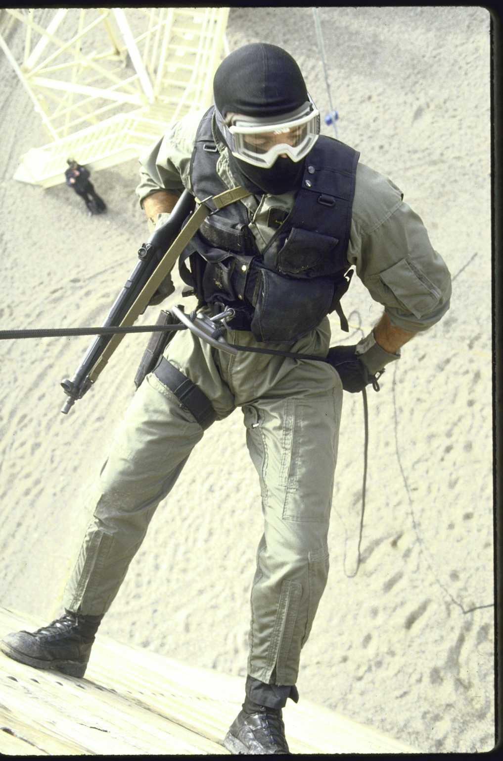 A specialized security force member rappels during a training exercise, symbolizing the human element in civilian nuclear security.