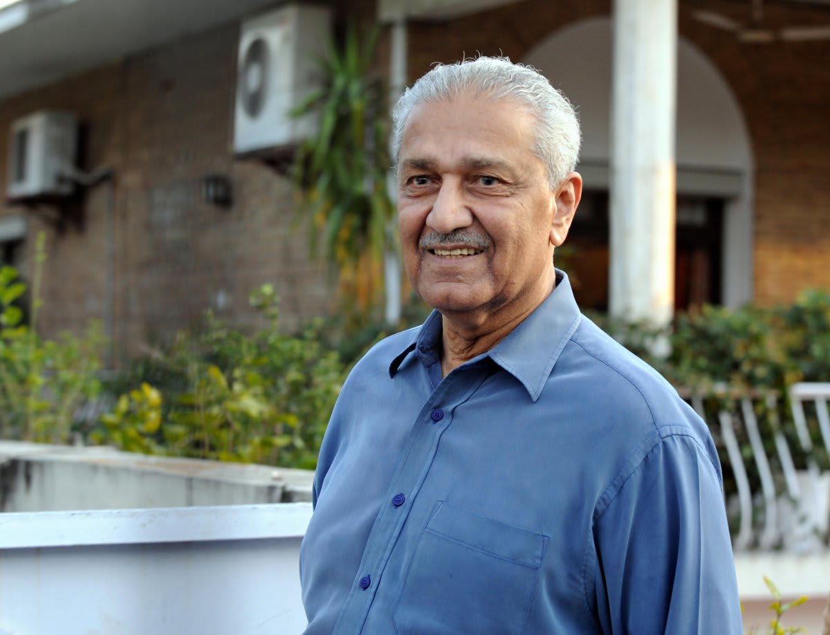Abdul Qadeer Khan, the Pakistani nuclear scientist, posing for a photograph outdoors.