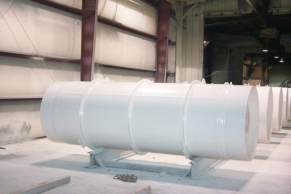 Large white cylinders for the storage and transport of uranium hexafluoride (UF6).
