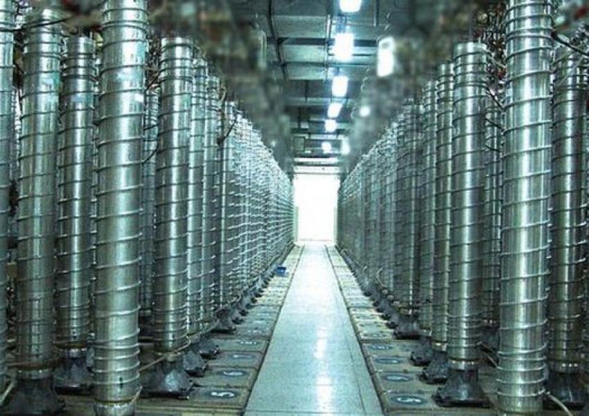 A cascade of centrifuges arranged for uranium enrichment within a nuclear facility.